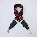 Adjustable black fabric bag strap featuring red heart embroidery and golden buckles - Heart