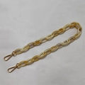 Macro detail of amber resin bag chain with polished gold metal lobster clasps - 60CM / Marled Beige