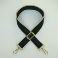 Detail view of adjustable black wide shoulder strap with gold metal lobster clasps - Black