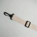Detail of adjustable off-white canvas strap with durable black plastic swivel hooks - Off-white