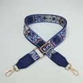 Detail of colorful ethnic pattern jacquard strap with gold lobster clasps and blue leather - No.5 Ink Flower + Blue Leather Trim