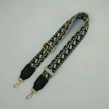 Detail of adjustable wide bag strap featuring black and white jacquard floral embroidery - Milan Pattern + Black Leather