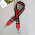 Detail of red and black striped woven bag strap with gold metal hooks and red leather - Black/Red/Black With Red Leather