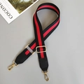 Detail of red and black striped canvas shoulder strap with gold metal lobster clasps - Black/Red/Black With Black Leather