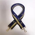Close-up of blue wide fabric bag strap with gold stars and metal swivel hooks - Blue