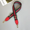 Detail of adjustable green and red striped canvas strap with gold swivel hooks and leather ends - Green/Red/Green With Red Leather