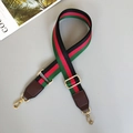 Detail of adjustable green and red striped canvas strap with gold metal hardware - Black/Red/Green With Coffee Leather