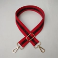 Adjustable red fabric shoulder strap with black lettering and gold metal hardware - Red