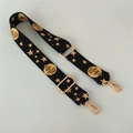 Detail of adjustable black strap with gold star print and metallic swivel hooks - Triangle Head Style