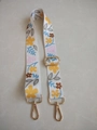 Close-up of floral canvas bag strap with golden metal buckles and adjustable slider - Style 4