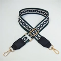 Close-up of wide fabric shoulder strap with geometric chain patterns and gold metal hooks - Silver Clasp / No.2 Green Circles + Black Leather Trim