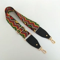 Macro detail of bohemian woven strap with geometric patterns and golden lobster clasps - Wave