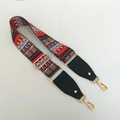Detail of ethnic geometric wide bag strap with gold lobster clasps and black leather ends - Ethnic