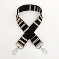 Detail of adjustable black and beige striped nylon shoulder strap with silver metal hooks - Rice Black Silver Buckle