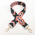 Detail of colorful geometric canvas strap with premium light gold metal hardware - Blue Green Orange / Silver Clasp