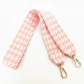 Close-up of pink houndstooth woven bag strap with luxury gold metal swivel hooks - Pink