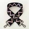 Close-up of adjustable wide woven bag strap with pink zigzag patterns and metal hardware - Black Pink Pattern Gunmetal Buckle
