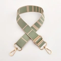 Macro detail of adjustable striped green and beige bag strap with gold metal hooks - Rice Green Gold Buckle