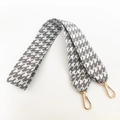 Detailed view of grey houndstooth thick wide bag strap with golden lobster clasps - Gray