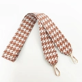 Macro detail of houndstooth woven replacement strap with golden metal lobster clasps - White Brown