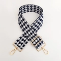 Detail eines verstellbaren schwarz-weißen Hahnentritt-Taschenriemens mit Gold-Schnallen - Nr. 21 Marineblau