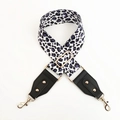 Close-up of adjustable leopard print wide strap with gold-tone hardware and leather ends - White Purple Leopard