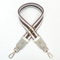 Close-up of adjustable striped bag strap with gold hooks and braided texture details - Nude Pink Khaki + Rice Grey Leather