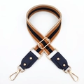 Detail of adjustable wide woven bag strap with retro stripes and golden metal hooks - Khaki + Blue Leather