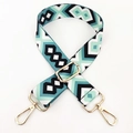 Close-up of geometric ethnic bag strap with golden metal hooks and adjustable buckle - Black White Green
