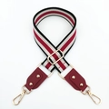 Detailed view of red and black striped canvas strap with gold hardware and leather ends - Black + Wine Red Leather