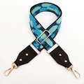 Detail of blue camouflage wide shoulder strap with golden metal carabiner and buckles - Black Edge Light Blue