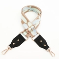 Close-up of colorful woven shoulder strap with gold studs and lobster clasps - Khaki Green Blue
