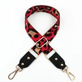 Detail of red leopard print wide bag strap with gold lobster clasps and hardware - Red + Black Leather