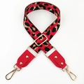 Detail of red leopard print wide bag strap with gold metal buckles and rivets - Red + Red Leather