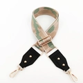 Macro view of adjustable camo shoulder strap with gold metal buckles and lobster clasps - Khaki Green