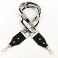 Macro view of wide geometric camouflage strap with premium gold hardware and lobster clasps - Khaki Black White Gray
