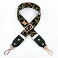 Detail of colorful leopard print nylon strap with gold hardware and green leather ends - Green + Green Leather