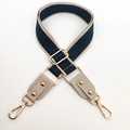Macro detail of adjustable nylon bag strap with navy geometric pattern and gold hardware - Starry Blue and Beige Gray