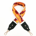 Close-up of a wide colorful geometric woven bag strap with adjustable gold metal buckles - Khaki Orange Yellow