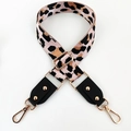 Detail of adjustable leopard print bag strap with gold metal hooks and pink webbing - Pink + Black Leather