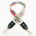 Detail of colorful jacquard flower guitar strap with green leather and gold hardware - Green