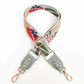 Close-up of thick floral jacquard strap with gold hardware and gray leather ends - Gray