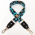 Detail of adjustable leopard print bag strap with golden metal hooks and leather trim - Aqua Blue + Black Leather