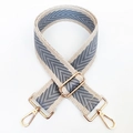 Detail of adjustable woven shoulder strap with grey chevron pattern and gold metal hooks - Khaki-Grey