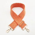 Detail of adjustable woven jacquard strap with orange geometric patterns and gold metal hooks - L9 Orange