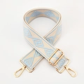 Detail of blue and beige geometric diamond pattern on wide woven adjustable bag strap - Beige Base Light Blue Diamond / Silver Clasp