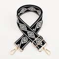 Detail view of 5cm wide geometric woven strap with adjustable golden metal hooks - Black Base White Diamond / Silver Clasp