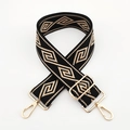 Detail of geometric pattern woven bag strap with golden metal swivel hooks and buckles - Black Base Khaki Diamond / Silver Clasp