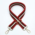 Close-up of adjustable woven bag strap with red geometric pattern and gold hardware - Red & White / Silver Clasp