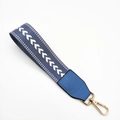 Close-up of blue and white woven wrist strap with gold metal lobster clasp and leather tab - Lake Blue